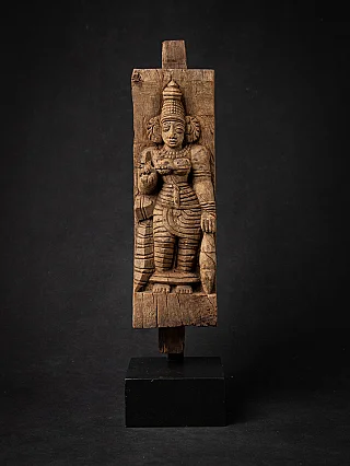 Wooden panel of the goddess Devi from India, full front view on a black display stand