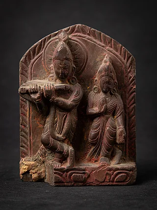 Antique stone carving of Krishna and Radha