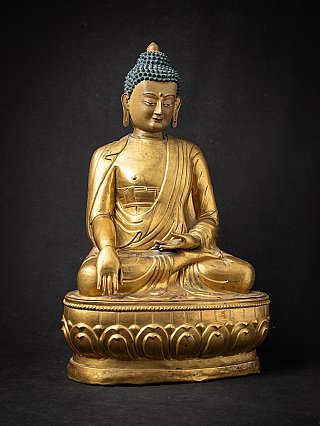 Tibetan wooden Buddha statue seated in bhumisparsha mudra, frontal view