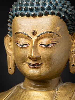 Close-up of the Buddha face with urna and painted eyelids
