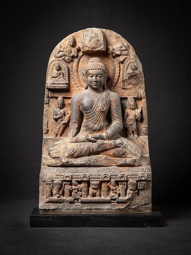 Buddha statue in Pala style from India, seated on carved base with stele, full front view