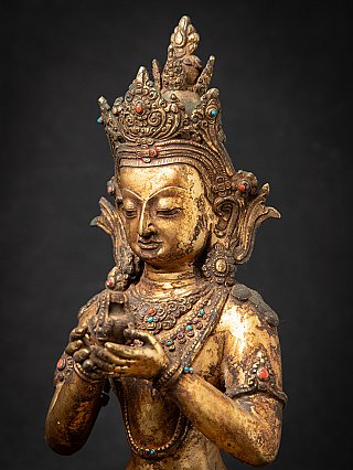 Three-quarter detail of head and hands on the Nepali bronze Aparmita Buddha statue