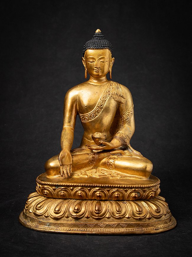 Nepali bronze Buddha statue seated on lotus base, full front view with varada mudra