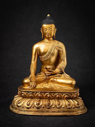 Nepali bronze Buddha statue seated on lotus base, full front view with varada mudra