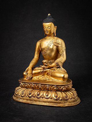 Bronze Buddha statue from Nepal, three-quarter view showing the bowl held in the hand