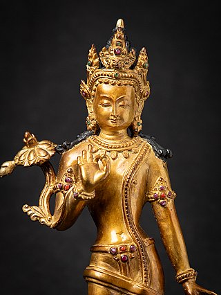 Face and crown detail of Lokeshwor bronze figure with coloured inlays