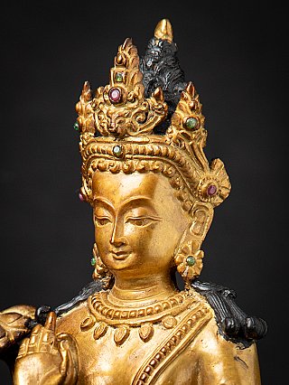 Three-quarter head detail of Lokeshwor bronze figure with crown and inlays