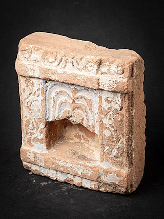 Stone temple shrine niche from India, angled left view with carved ornament band above
