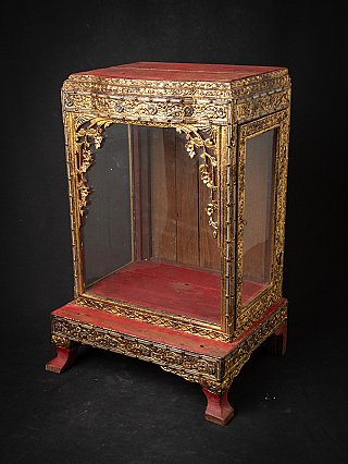 Wooden Burmese Buddha shrine, three-quarter view with red top panel and glass walls