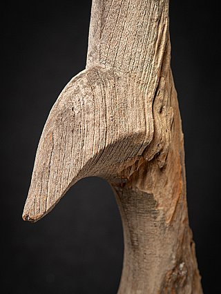 Detail of the projecting edge on the wooden chofa, showing rough carved surface