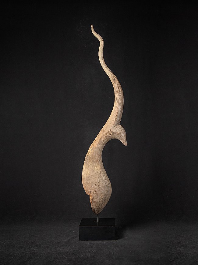 Antique Thai wooden temple chofa on stand, three-quarter view with long curved finial