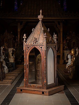 Indian wooden temple shrine, three-quarter view with glass door and steep roof