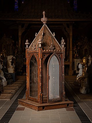 Indian wooden temple shrine, three-quarter view showing side glass panels and trim