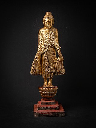 Burmese wooden Buddha statue, gilded, full-front view on lotus base and red plinth