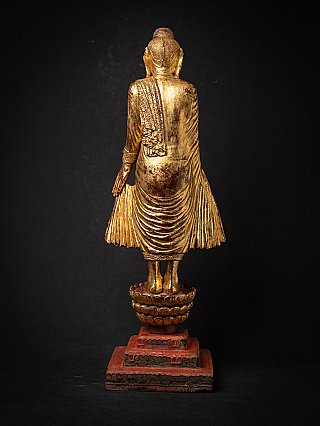 Mandalay Burmese wooden Buddha statue, gilded, rear view with robe folds