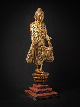 Gilded Burmese wooden Buddha statue, three-quarter right view with ornate robe