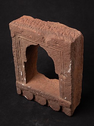 Indian stone temple niche in high angled view showing the top surface and frame