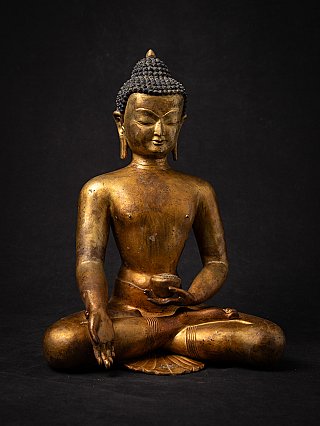 Bronze Nepali Buddha statue seated, frontal view with bowl and varada mudra gesture