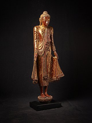 Burmese wooden Buddha statue in Mandalay style, three-quarter view with flowing robe