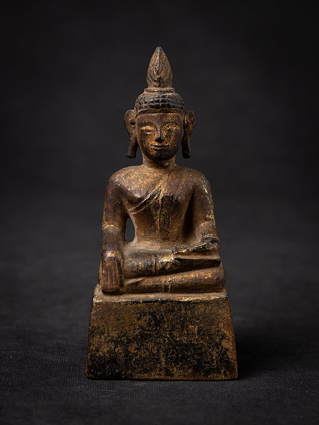 Thai wooden Buddha statue seated in bhumisparsha mudra, full front view on base