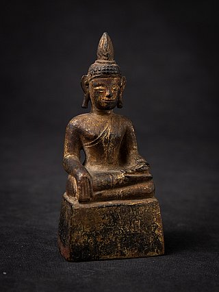 Thai wooden Buddha statue on base, seated bhumisparsha mudra, angled view