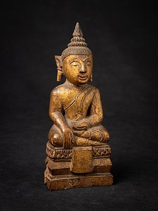 Thai wooden Buddha statue seated, three-quarter right view