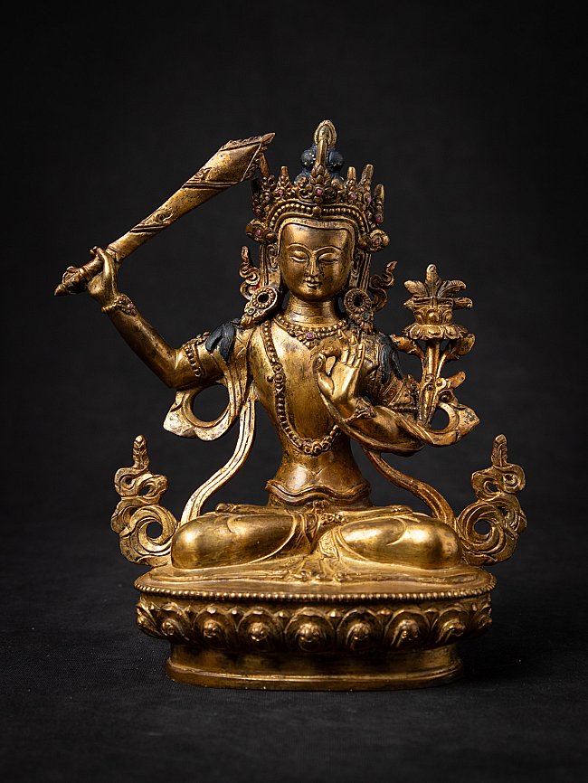 Manjushri Buddha statue in bronze from Nepal, seated with sword and lotus, full front