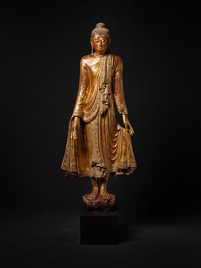 Burmese Mandalay Buddha statue in wood, full front view on pedestal