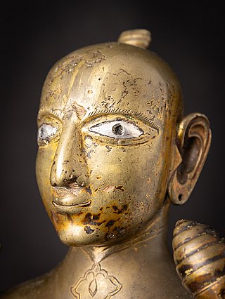 Side face detail of the bronze Vishnu statue showing ear and cheek patina