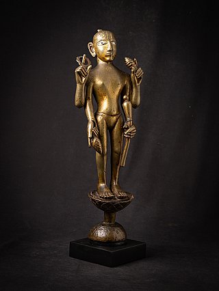 Vishnu bronze statue on pedestal, three-quarter view showing stance and four arms