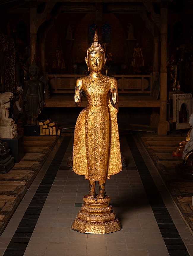 Thai bronze Buddha statue standing on pedestal, full-front view with Abhaya mudra