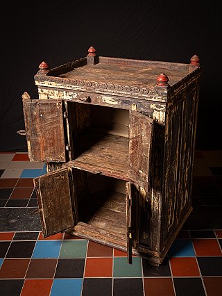 Wooden Indian cabinet with doors open, angled top view showing the upper surface and shelves