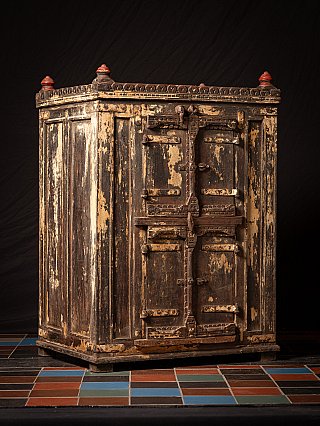 Antique wooden Indian cabinet, three-quarter view highlighting the door crossbar and metal strapwork