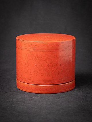 Burmese lacquerware betelnut box with lid, red round form with incised floral pattern