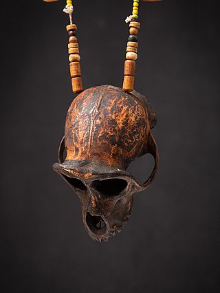 Wooden monkey skull hanging from the necklace, three-quarter view