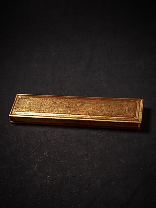 Kammavaca manuscript from Burma (Myanmar), closed wooden cover with gilding and red decoration, angled view