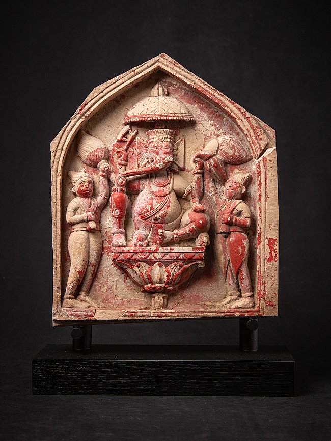 Ganesha-reliëf uit India met rode pigmentresten, frontaal in nisvormig paneel