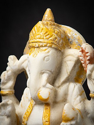 Close-up angled view of the marble Ganesha head with crown and trunk