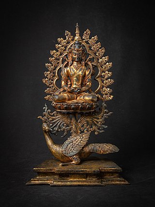 Bronze Buddha statue from Nepal, seated with ornate halo and bird base, full front