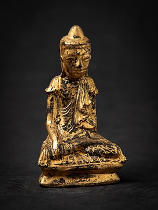 Burmese wooden Buddha statue in bhumisparsha mudra, angled front view