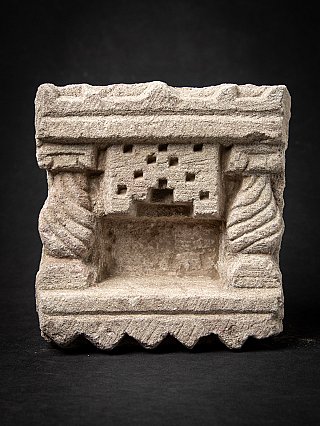 Indian stone shrine, front view showing the niche, twisted pillars and sawtooth base