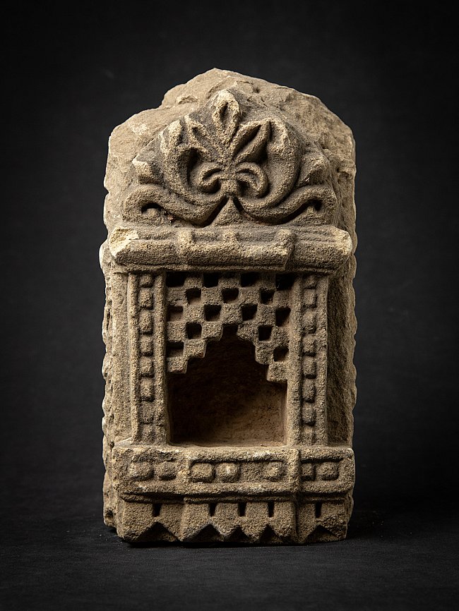 Antique Indian stone temple niche, front view with open recess and floral crest