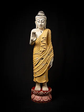 Burmese wooden Buddha statue standing on a red lotus base, full front view