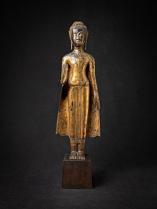 Thai bronze Buddha statue standing in Abhaya mudra, full front view on wooden base