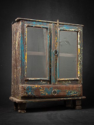 Antique wooden Indian cabinet with glass doors, three-quarter left view with lower drawer