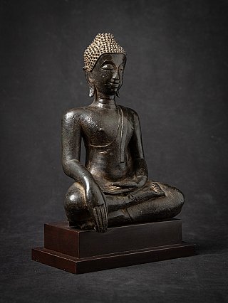 Bronze Buddha statue from Thailand, three-quarter view seated on stepped wooden base