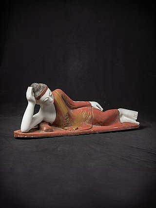 Reclining marble Buddha statue, three-quarter front view showing face and robe