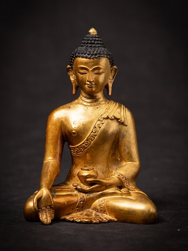 Nepali bronze Buddha statue, seated full-front view with right hand in varada mudra