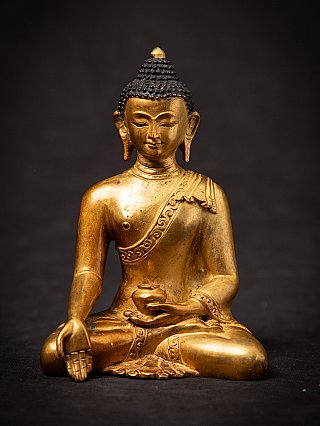 Nepali bronze Buddha statue, seated full-front view with right hand in varada mudra