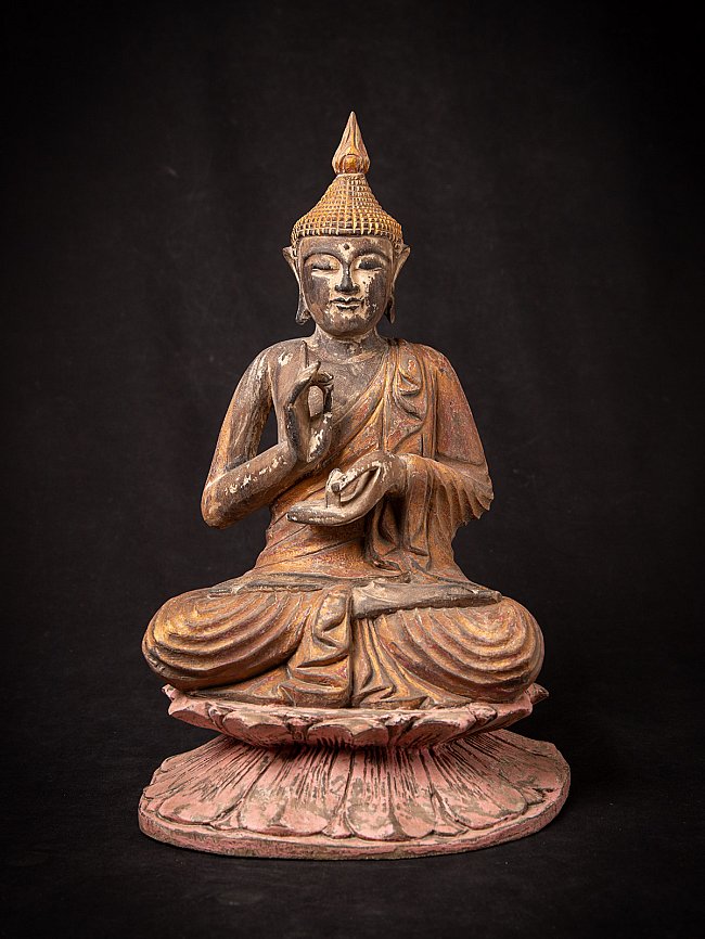Thai wooden Buddha statue seated on a lotus base, full front view